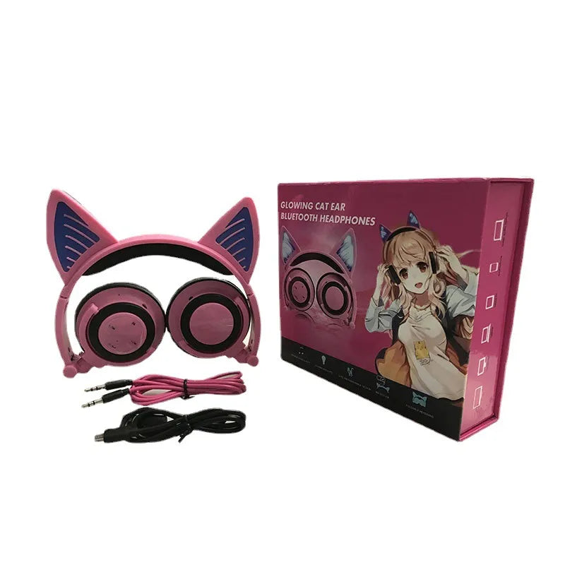Pink cat ear headphones with packaging on a white background
