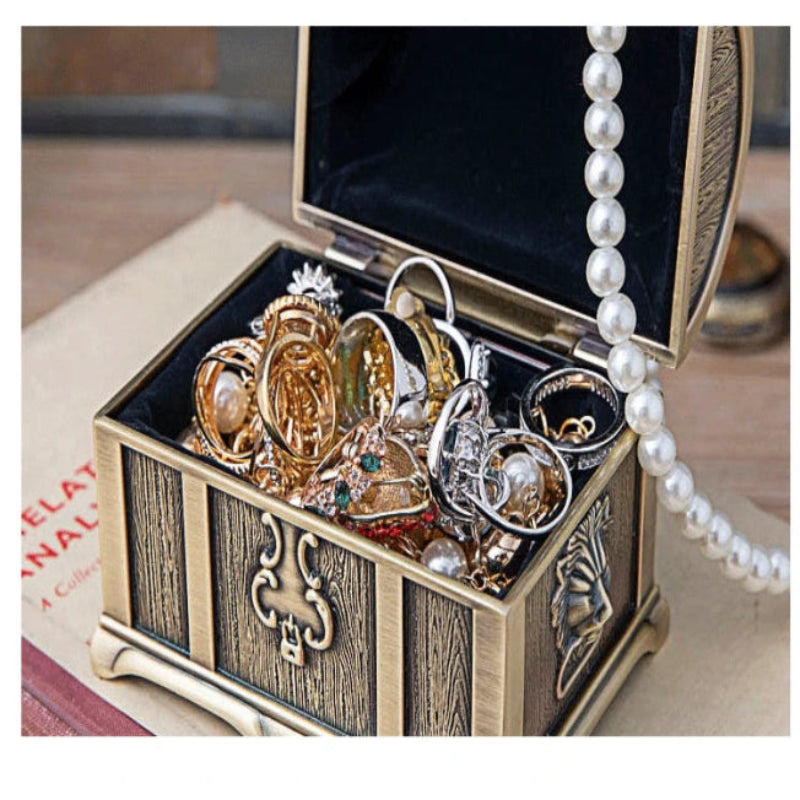 Jewelry box with rings and a pearl necklace on a blurred background