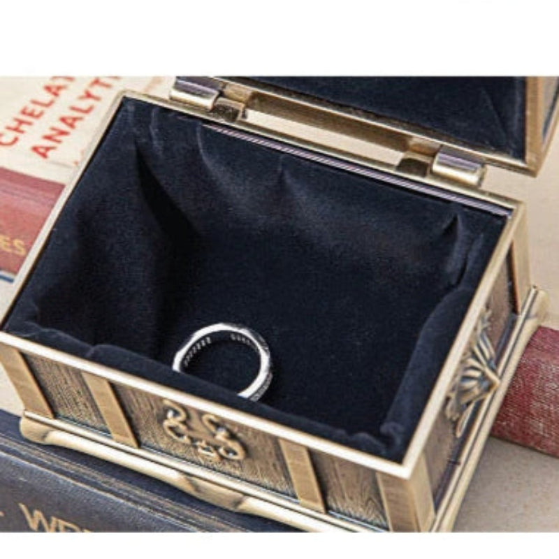 Decorative jewelry box with a lion emblem on a wooden surface