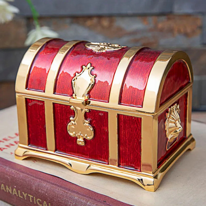 Red jewelry box with gold accents on a surface