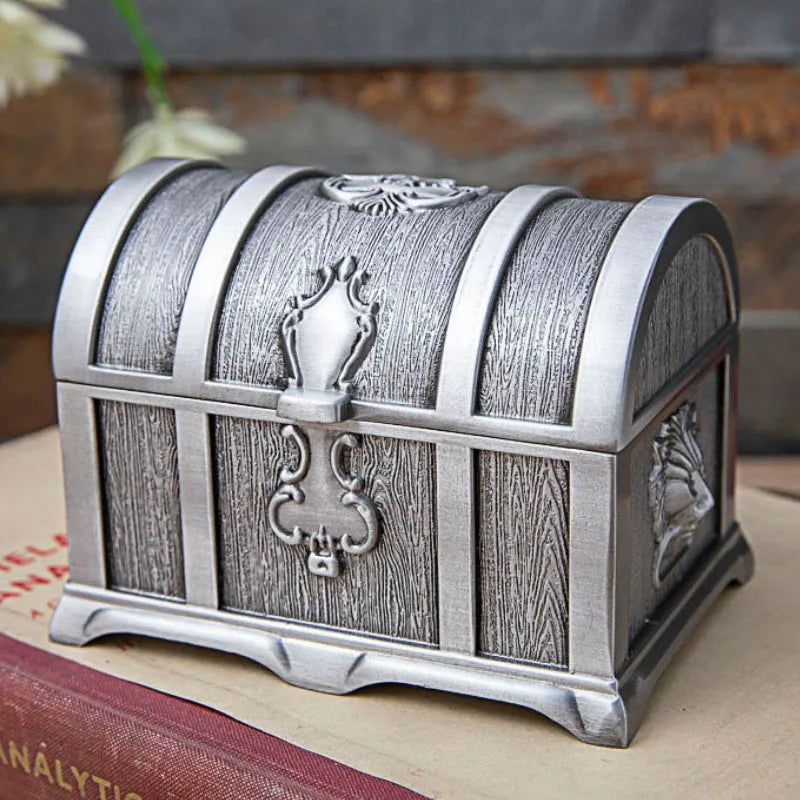Decorative silver and wooden chest on a surface with a blurred background