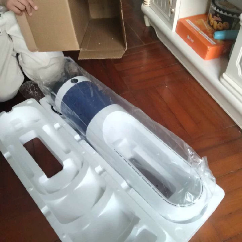 Unboxed electronic device with protective packaging on a wooden floor