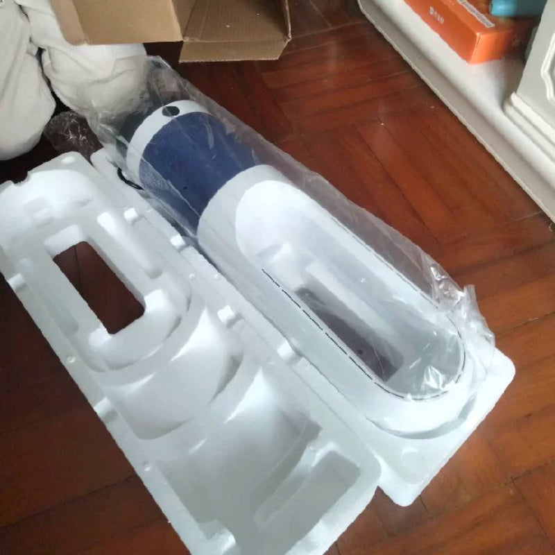 Unboxed electronic device with protective packaging on a wooden floor