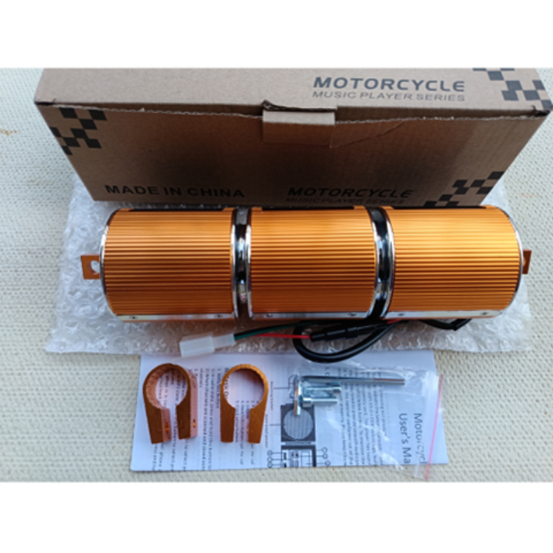 Motorcycle music player with packaging and accessories on a white surface