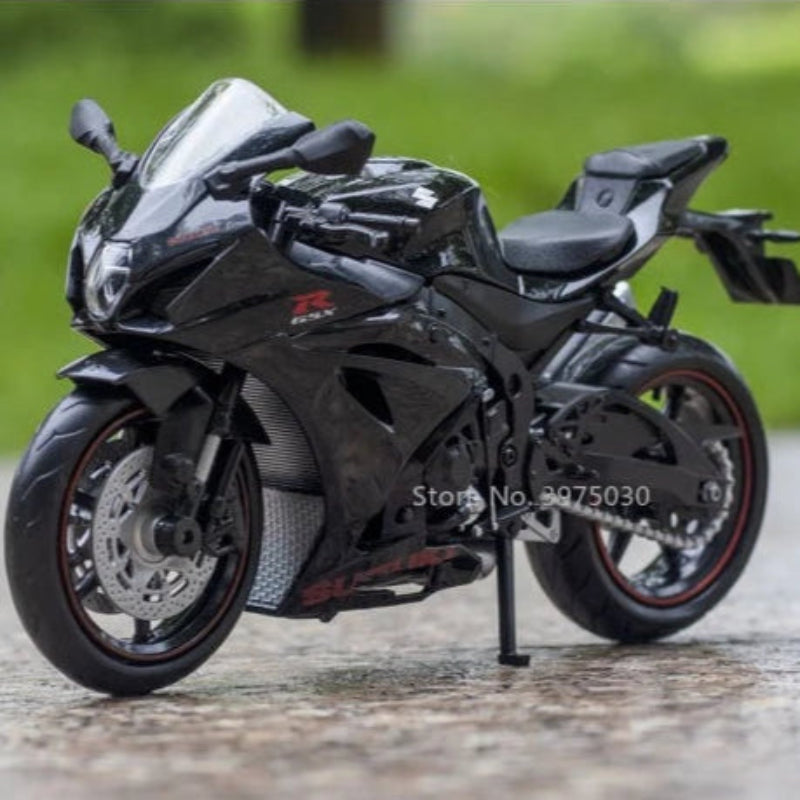 Black motorcycle model on a stand with a blurred green background