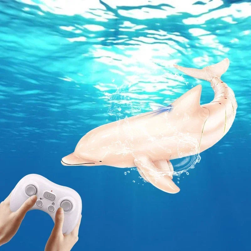 Remote-controlled toy dolphin swimming underwater with a controller held by a person above.