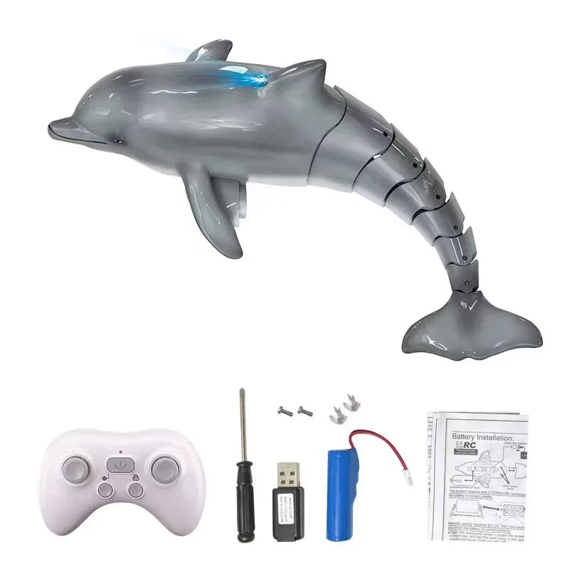 Toy dolphin with remote control, battery pack, and installation manual on a white background