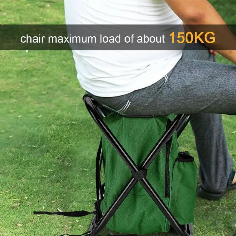 Person sitting on a green folding chair with a maximum load capacity of 150KG on grass.