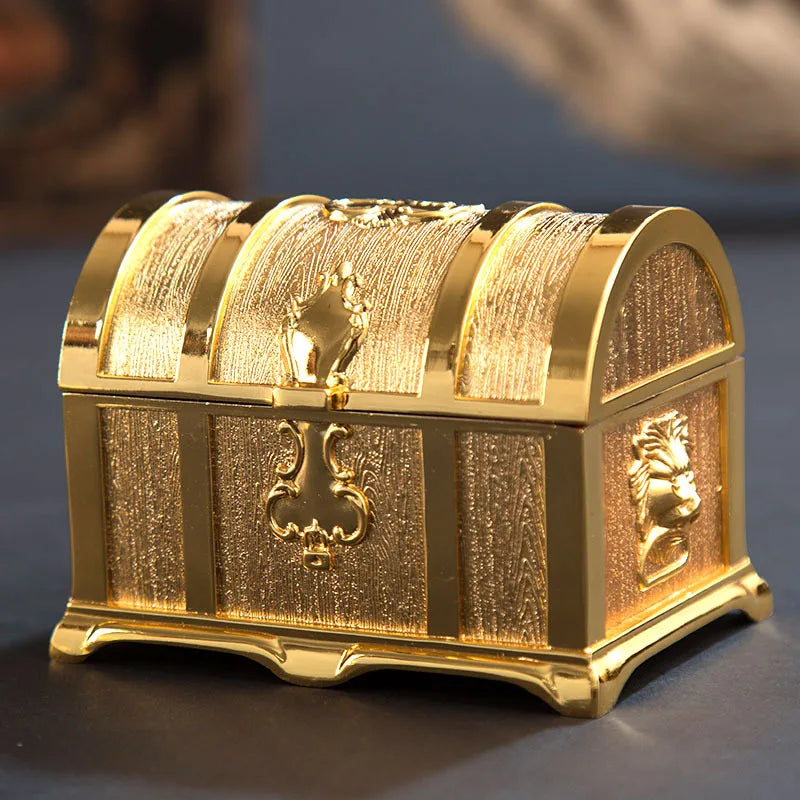 Gold treasure chest with intricate designs on a dark background