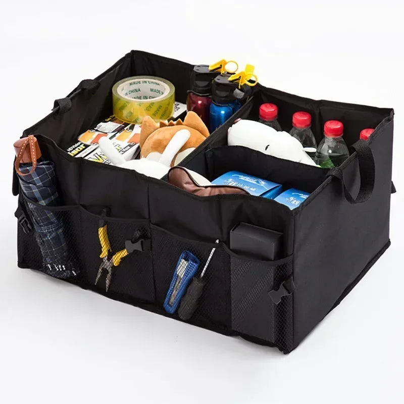 Black car trunk organizer with various items inside on a white background