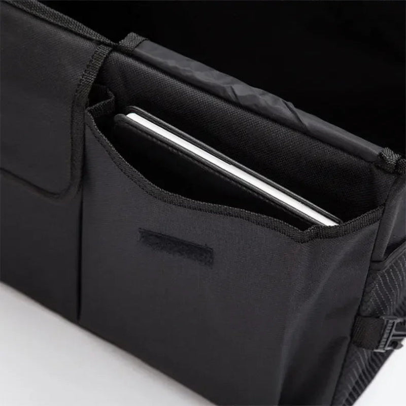 Black bag with a compartment holding a white tablet