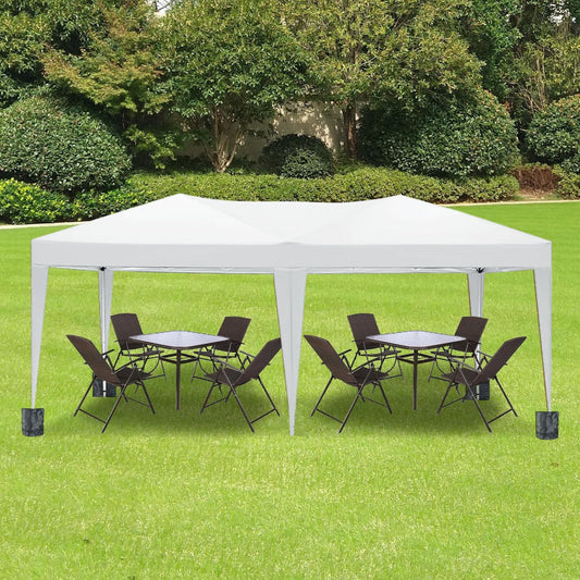 White outdoor canopy tent with tables and chairs on a grassy area with trees in the background