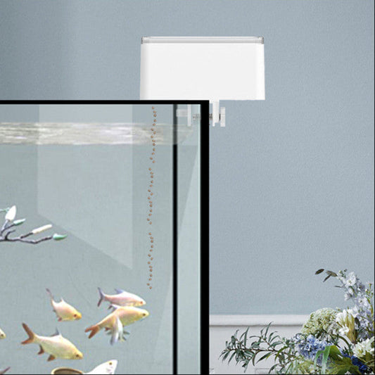 Fish tank with fish, a lamp, and decorative elements on a light blue background
