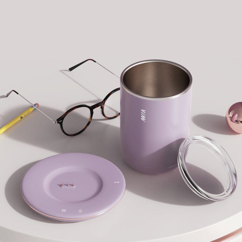Purple tumbler with lid, glasses, and pencil on a light surface