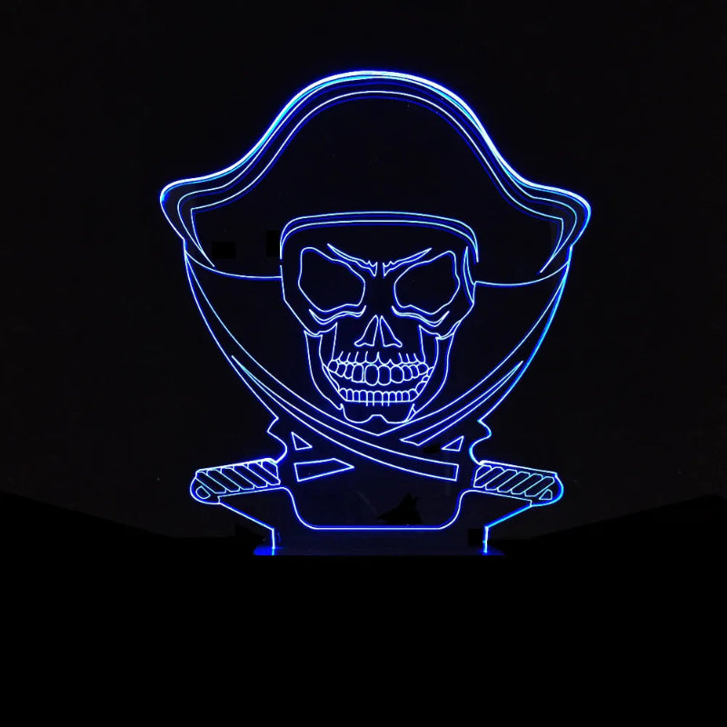 A pirate skull LED night light glowing with a bright blue light against a solid black background.