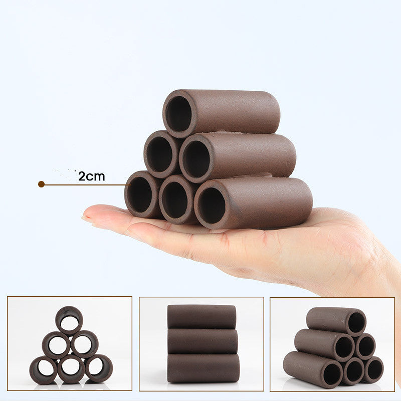 Stack of brown cylindrical objects held in a hand with size indication, on a white background.