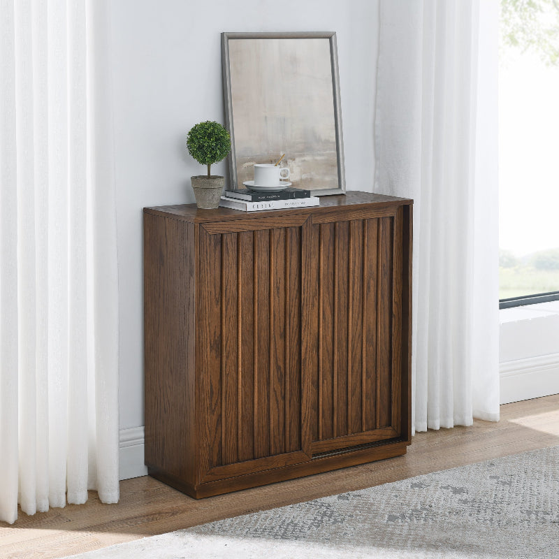 Wooden sideboard with decorative items against a white wall