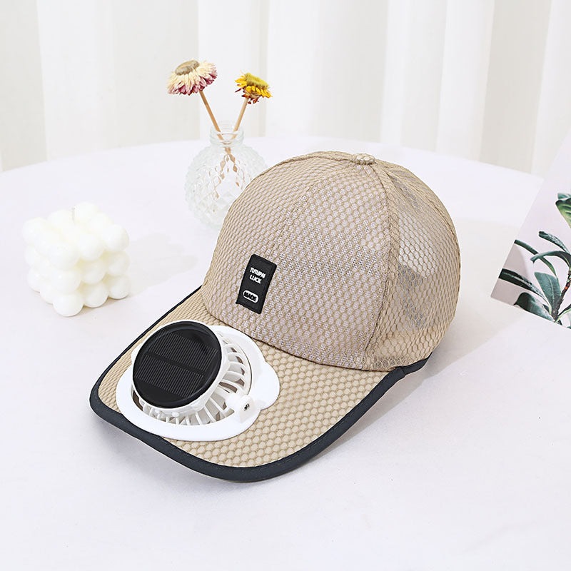 Beige cap with a built-in fan on a white surface with a light background