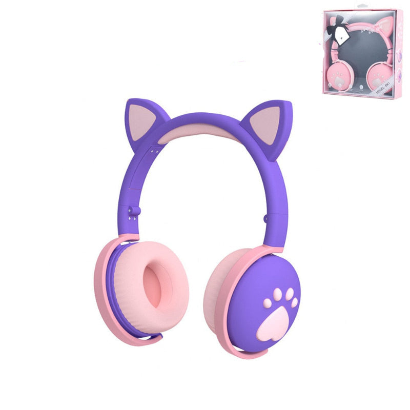 Purple and pink headphones with cat ears and paw print design, including a package box on a white background.