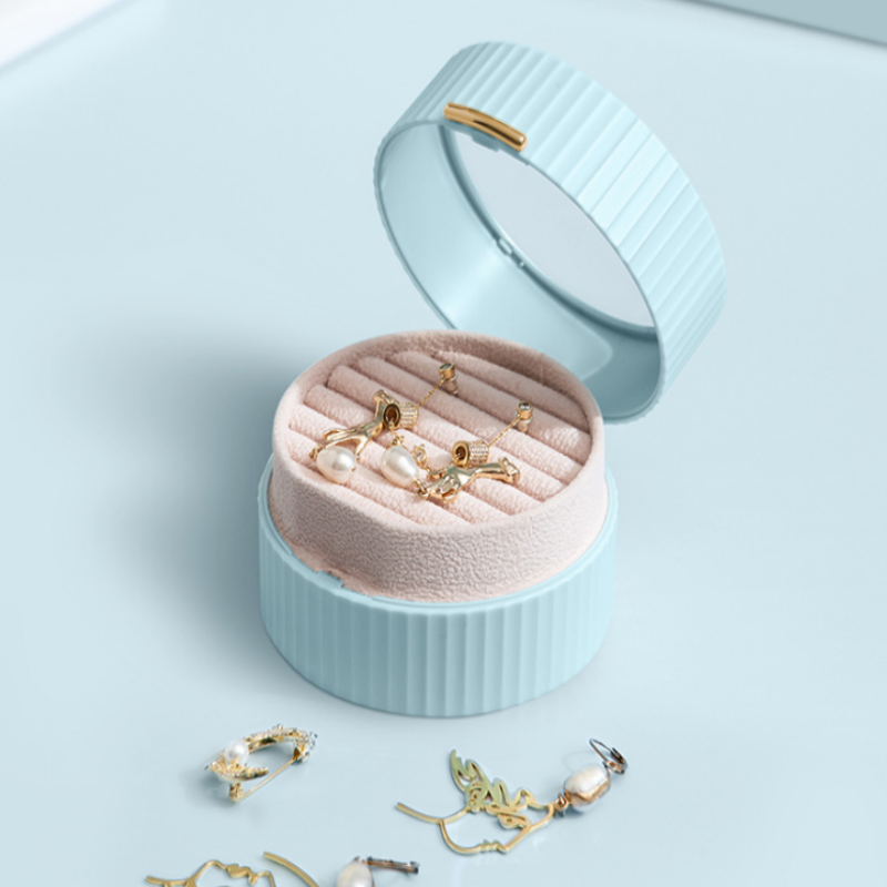 Jewelry box with earrings on a light blue background