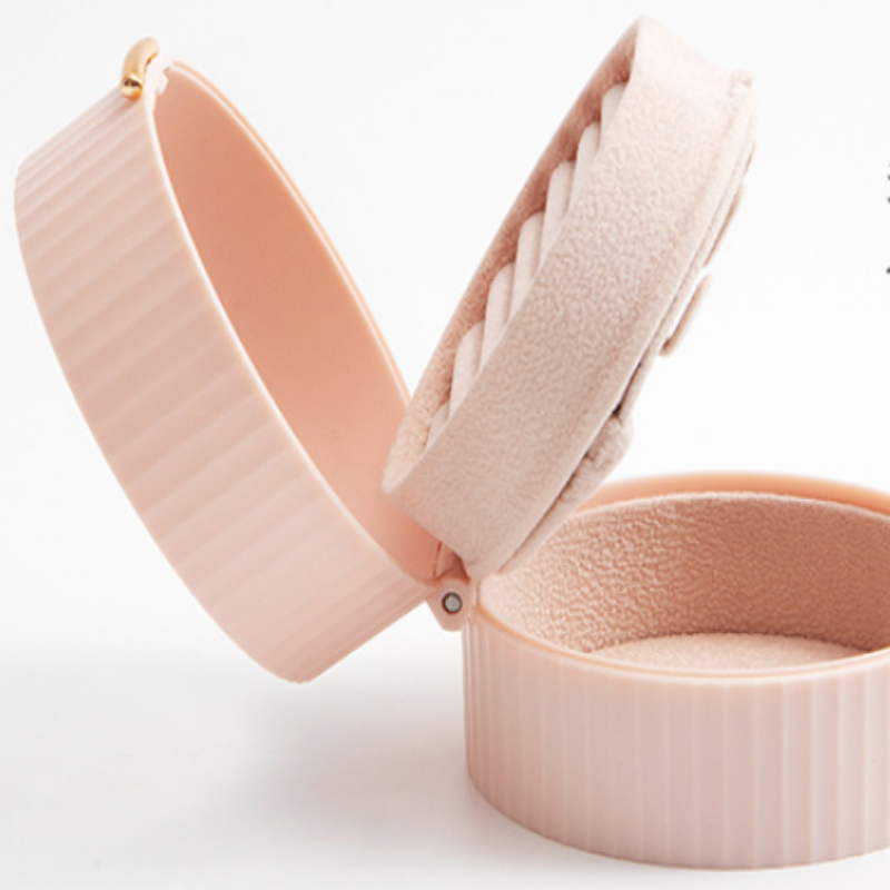 Open pink jewelry box on a white background