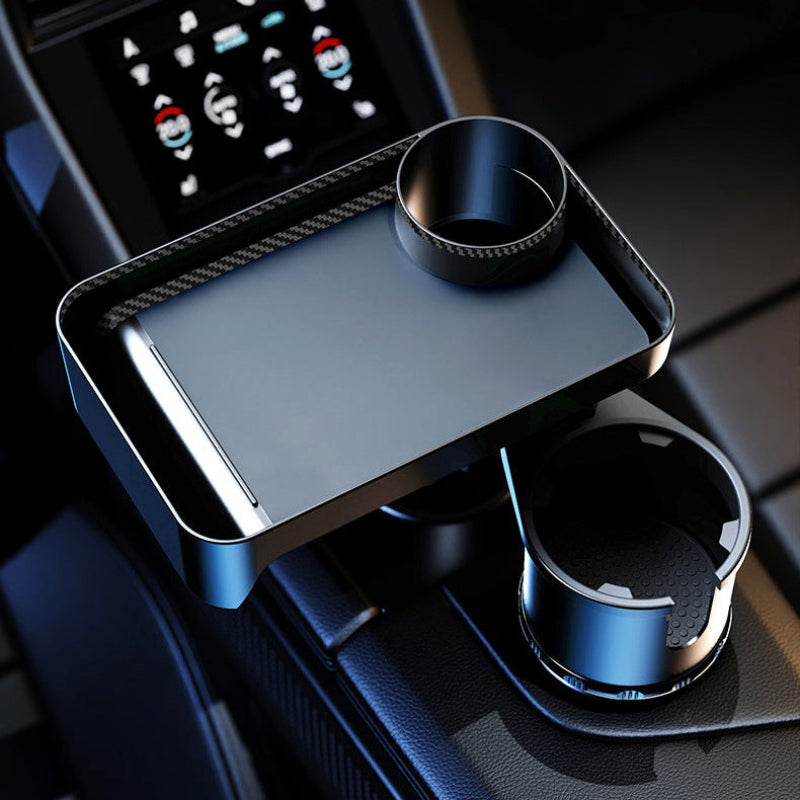 Car cup holder with phone stand and air freshener in a vehicle interior.