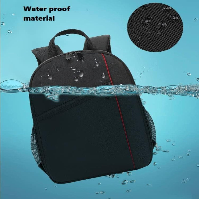 Black backpack with water droplets on it, submerged in water with 'Waterproof material' text above.