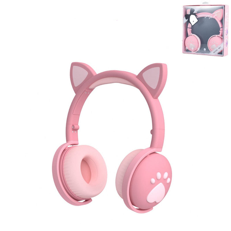Pink headphones with cat ears and paw design on a white background, including a package box.