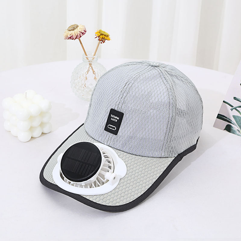 Gray cap with solar fan attachment on a white surface