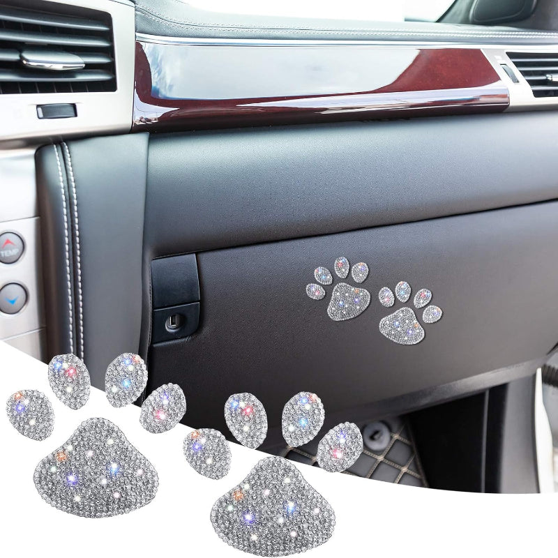 Decorative paw-shaped stickers with rhinestones on a car dashboard