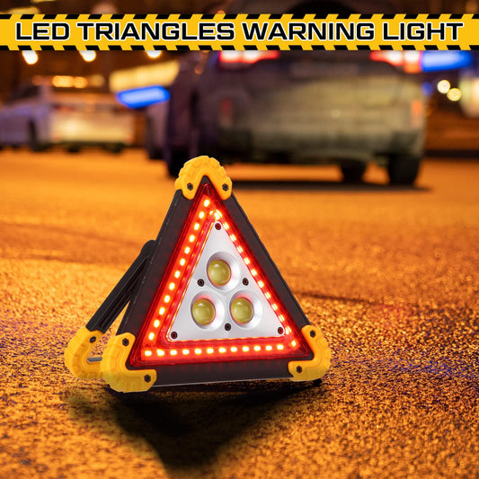 Triangular warning light on a road with vehicles in the background