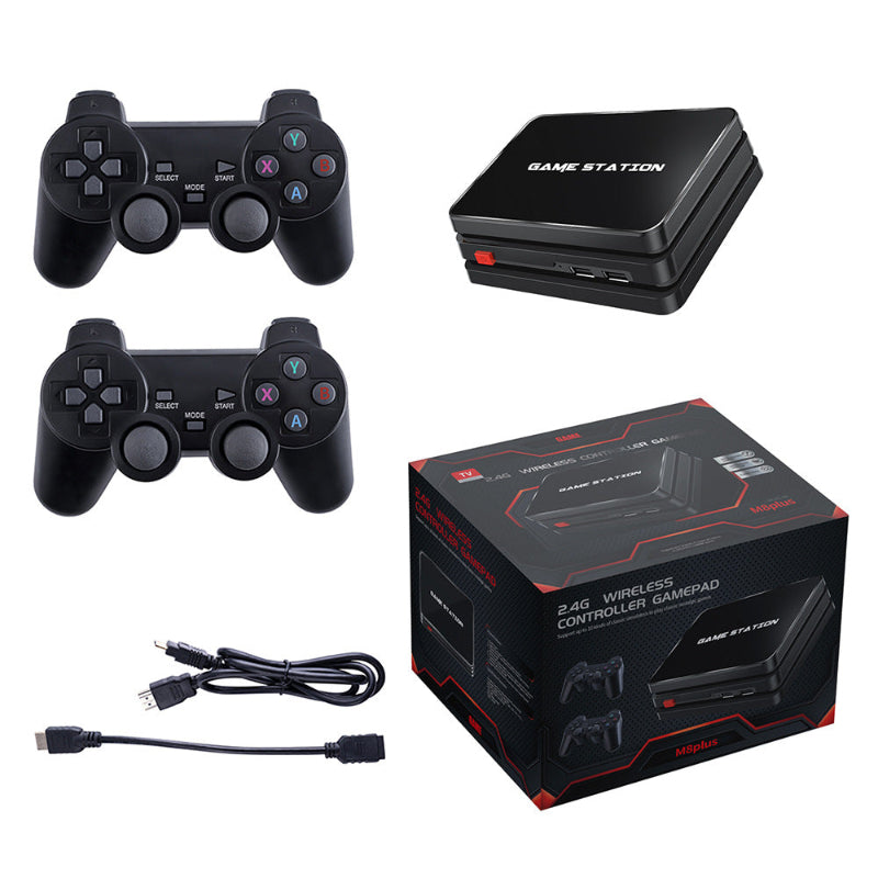 Black gaming console with two controllers, cable, and packaging on a white background
