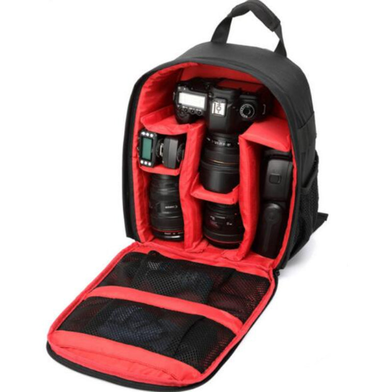 Camera backpack with red interior compartments containing camera equipment on a white background