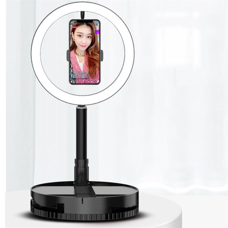 Makeup mirror with a round lighted area and smartphone holder on a white background