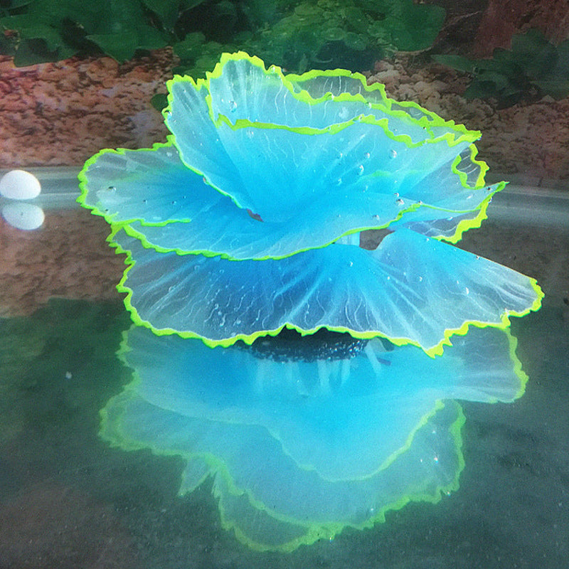 Glowing blue and green jellyfish-like creature on a reflective surface