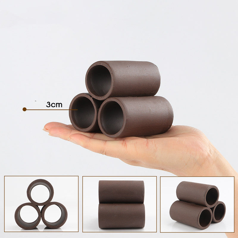 Three brown cylindrical objects stacked on a hand with a 3cm measurement label, set against a white background.