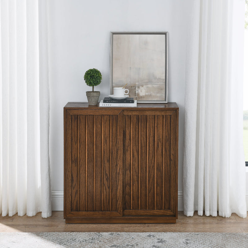 Wooden sideboard with decorative items against a white wall