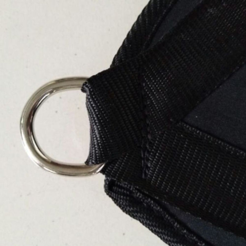 Close-up of a black strap with a metal D-ring on a light gray background
