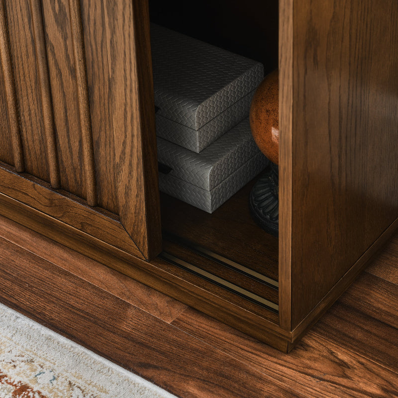 Wooden cabinet with a stack of gray cushions inside