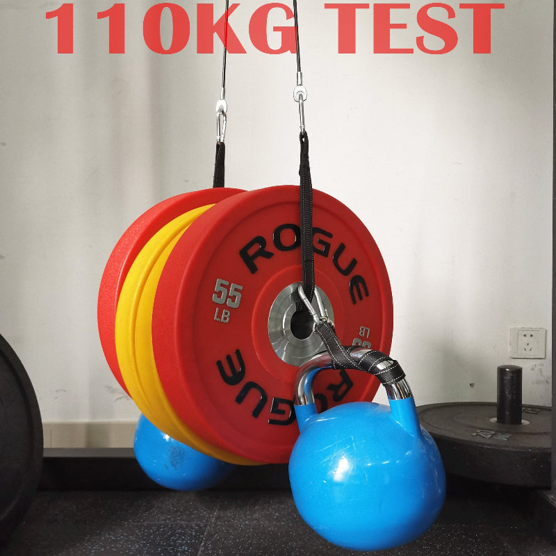 Weightlifting equipment with red and yellow weights labeled 'Rogue' and blue ball on a gym floor.