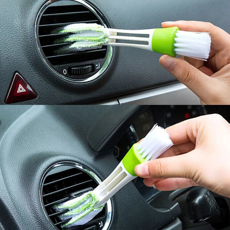 Car air vent cleaning brush being used on a car's air vent.