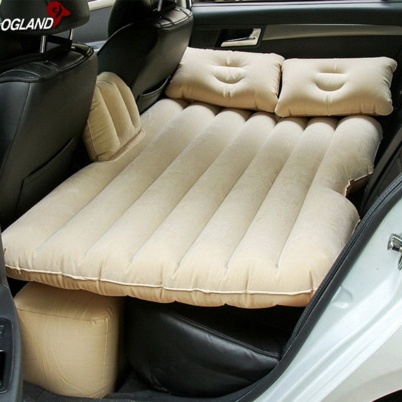 Inflatable car mattress set up in the back of a vehicle with OGLAND branding.