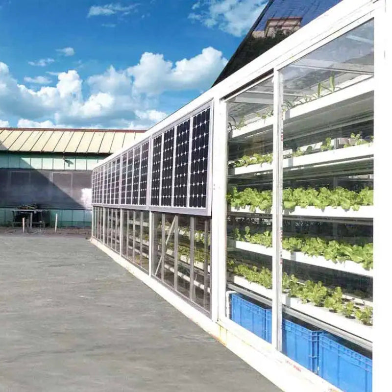 Solar panels on a building with vertical hydroponic gardens below.