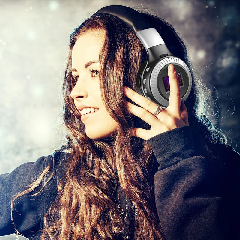 Woman wearing large headphones with a blurred background
