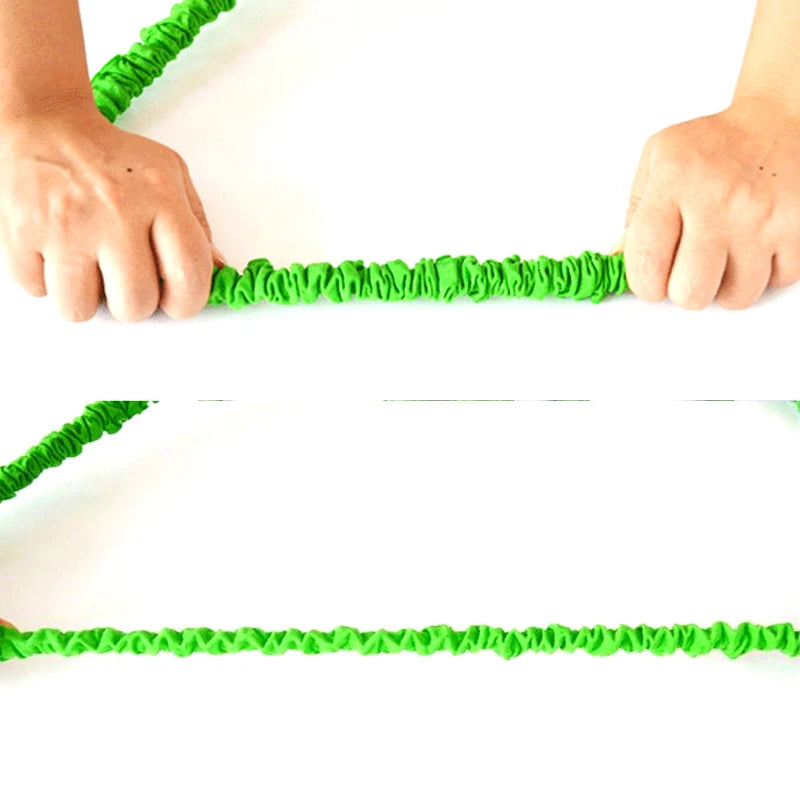 Green jump rope being held by a person on a white background