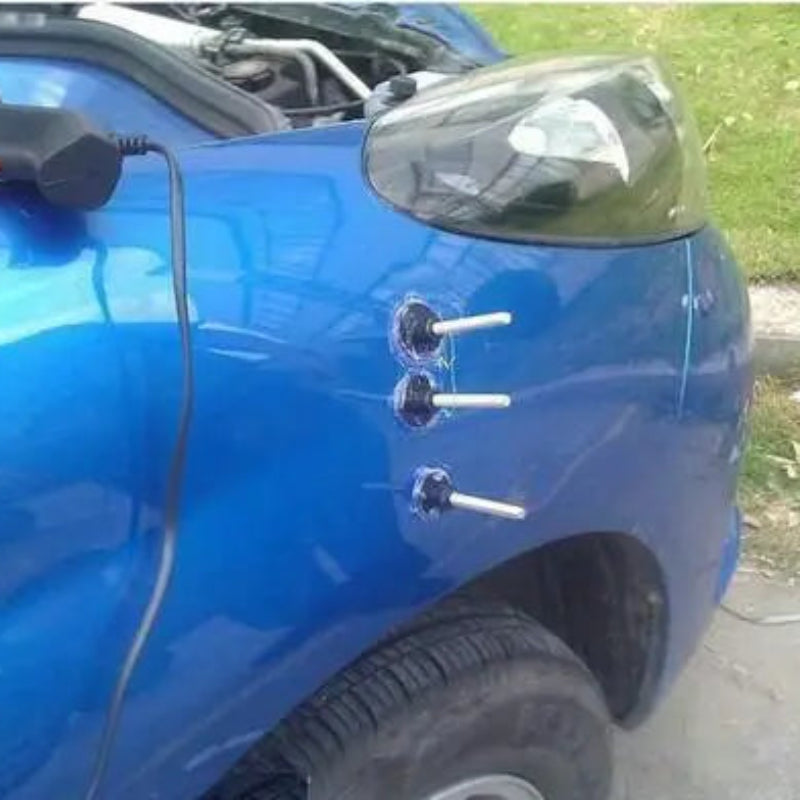 Blue car with charging cable and visible charging ports outdoors