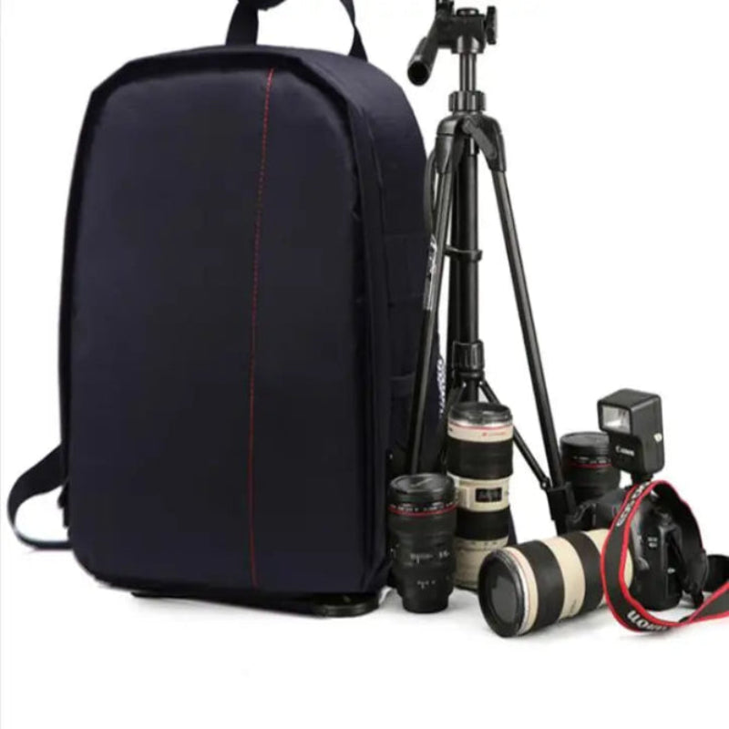 Black backpack with camera equipment including lenses and a tripod on a white background