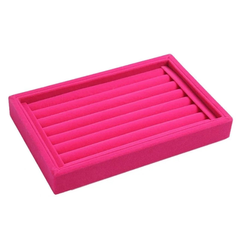 Pink jewelry tray with multiple compartments on a white background