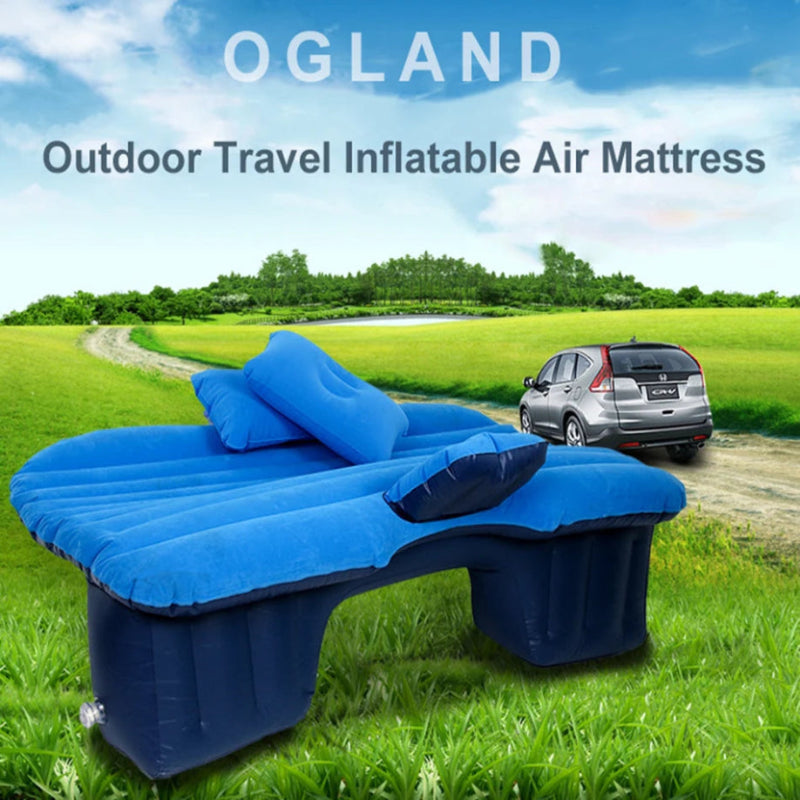 Blue inflatable air mattress on grass with a car in the background and 'OGLAND' branding.