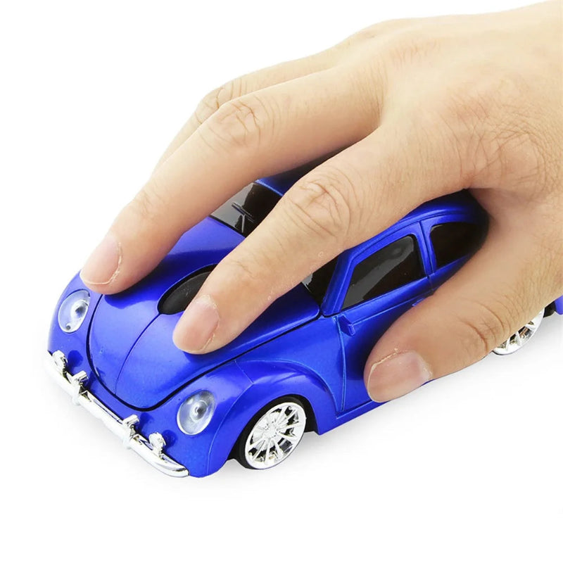 Blue toy car with a hand pressing on it against a white background